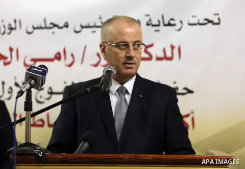 Palestinian Prime Minister Rami Hamdallah speaks during the graduation ceremony of the first group of Palestinian officers academy students, in the West Bank city of Jericho, on December 19, 2016. Photo by Prime Minister...