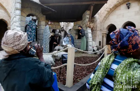 Africans Christian pilgrims visit the Church of the Nativity, revered as the site of Jesus Christ's birth, on December 22, 2016 in the biblical West Bank town of Bethlehem. Photo by Wisam Hashlamoun