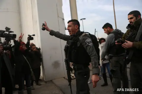 Palestinian protesters argue with an Israeli border guard during clashes at a demonstration next to a section of Israel's separation wall in the biblical town of Bethlehem, in the occupied West Bank, on December 23, 2016...