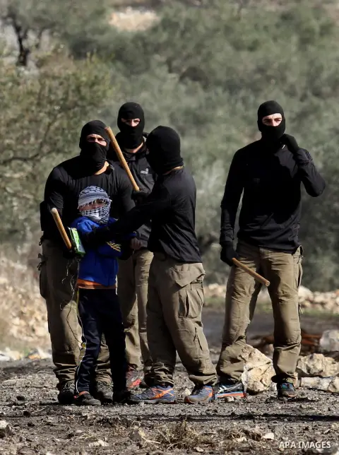 Masked members of the Israeli security forces briefly detain a Palestinian boy during clashes following a demonstration against the expropriation of Palestinian land by Israel in the village of Kfar Qaddum, near Nablus,...