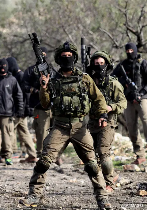 Israeli security forces take position near the settlement of Kadumim during clashes following a demonstration against the expropriation of Palestinian land by Israel in the village of Kfar Qaddum, in the occupied West Ba...