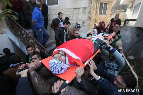 Mourners carry the body of Palestinian Jihad Khalil, who according to the Israeli police was shot and killed by an Israeli security guard after Khalil tried to stab him last November, during his funeral after Israel rele...
