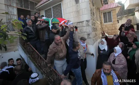 Mourners carry the body of Palestinian Jihad Khalil, who according to the Israeli police was shot and killed by an Israeli security guard after Khalil tried to stab him last November, during his funeral after Israel rele...