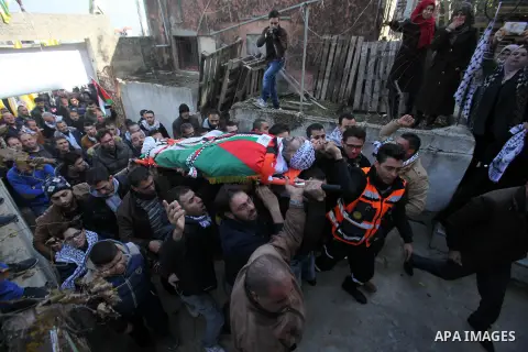 Mourners carry the body of Palestinian Jihad Khalil, who according to the Israeli police was shot and killed by an Israeli security guard after Khalil tried to stab him last November, during his funeral after Israel rele...