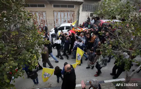 Mourners carry the body of Palestinian Jihad Khalil, who according to the Israeli police was shot and killed by an Israeli security guard after Khalil tried to stab him last November, during his funeral after Israel rele...