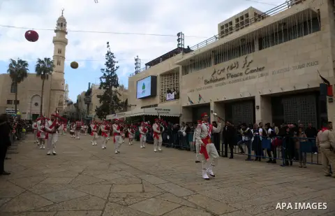 Palestinian Christian scouts perform at the Manger Square outside the Church of the Nativity as people gather for Christmas celebrations in the city of Bethlehem in the Israeli-occupied West Bank, on December 24, 2016. P...