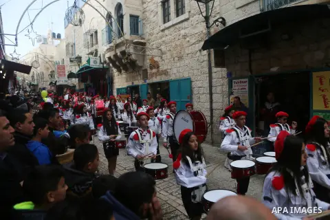 Palestinian Christian scouts perform at the Manger Square outside the Church of the Nativity as people gather for Christmas celebrations in the city of Bethlehem in the Israeli-occupied West Bank, on December 24, 2016. P...