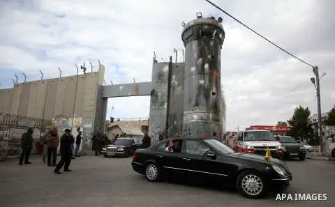 The Latin Patriarch of Jerusalem Pierbattista Pizzaballa is greeted upon his arrival through an Israeli checkpoint to attend Christmas celebrations, in the West Bank city of Bethlehem December 24, 2016. Photo by Wisam Ha...