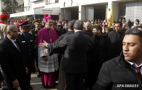 The Latin Patriarch of Jerusalem Pierbattista Pizzaballa is greeted upon his arrival through an Israeli checkpoint to attend Christmas celebrations, in the West Bank city of Bethlehem December 24, 2016. Photo by Wisam Ha...
