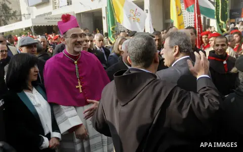 The Latin Patriarch of Jerusalem Pierbattista Pizzaballa is greeted upon his arrival through an Israeli checkpoint to attend Christmas celebrations, in the West Bank city of Bethlehem December 24, 2016. Photo by Wisam Ha...