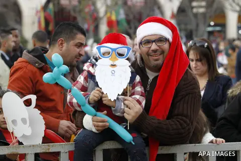 Palestinians attend a Christian scouts performance at the Manger Square outside the Church of the Nativity during Christmas celebrations, in the city of Bethlehem in the Israeli-occupied West Bank, on December 24, 2016....