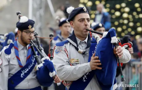 Palestinian Christian scouts perform at the Manger Square outside the Church of the Nativity as people gather for Christmas celebrations in the city of Bethlehem in the Israeli-occupied West Bank, on December 24, 2016. P...