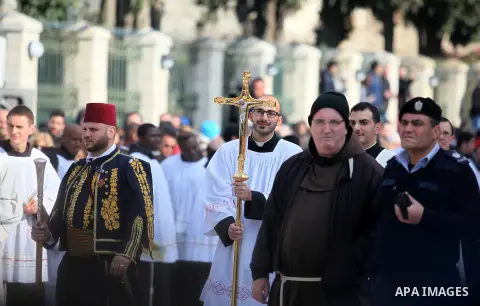 Clergymen wait for the arrival of the Latin Patriarch of Jerusalem Pierbattista Pizzaballa during Christmas celebrations, outside the Church of the Nativity in the West Bank city of Bethlehem December 24, 2016. Photo by...