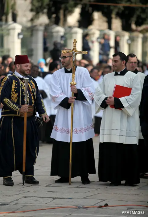 Clergymen wait for the arrival of the Latin Patriarch of Jerusalem Pierbattista Pizzaballa during Christmas celebrations, outside the Church of the Nativity in the West Bank city of Bethlehem December 24, 2016. Photo by...