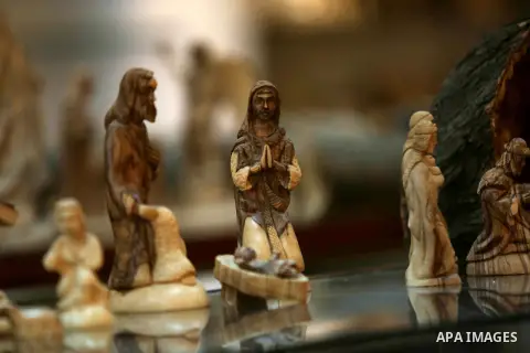 A woden effigies of the the Holy Family are seen at a workshop in the West Bank town of Bethlehem, on December 26, 2016. The traditional birthplace of Jesus Christ prepares to celebrate Christmas. Photo by Shadi Hatem