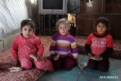 Palestinian children from Abu Jamea family play inside their house which was destroyed during the 50-day war between Israel and Hamas militants in the summer of 2014, on in Khan Younis in the southern Gaza Strip December...