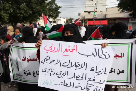 Palestinian workers shout slogans during a protest against the siege of Gaza, in Gaza City, on December 27, 2016. Photo by Ashraf Amra