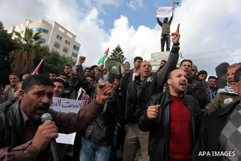 Palestinian workers shout slogans during a protest against the siege of Gaza, in Gaza City, on December 27, 2016. Photo by Ashraf Amra