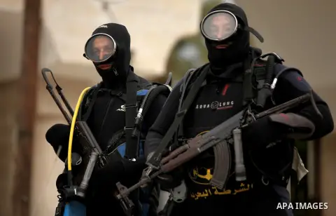 Palestinian naval security forces march during a rally marking the Eighth anniversary of the Israeli attack on Gaza strip in 2009, in Gaza city on December 28, 2016. Photo by Ashraf Amra