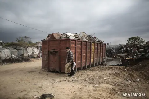 A Palestinian man walks outside his house during rainy, cold weather in a slum on the outskirts of Khan Younis refugee camp, southern Gaza Strip, on December 28, 2016. Photo by Mohammed Dahman