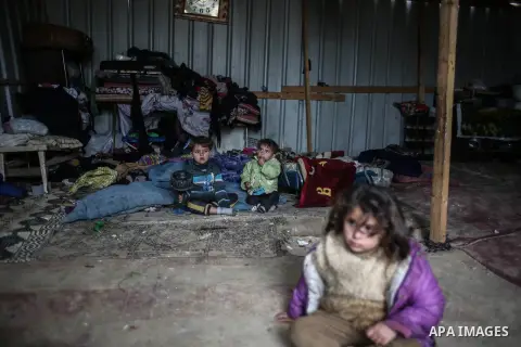 Palestinian children sit inside their family house during rainy, cold weather in a slum on the outskirts of Khan Younis refugee camp, southern Gaza Strip, Wednesday, on December 28, 2016. Photo by Mohammed Dahman
