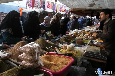 Palestinians shop at a market in Rafah in the southern of Gaza strip, on December 31, 2016. Photo by Abed Rahim Khatib