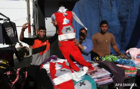 Palestinians shop at a market in Rafah in the southern of Gaza strip, on December 31, 2016. Photo by Abed Rahim Khatib
