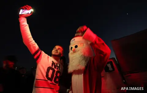 A Palestinian man in Santa Claus costume takes part in the celebration of the New Year at the Gaza seaport, on December 31, 2016. Photo by Ashraf Amra