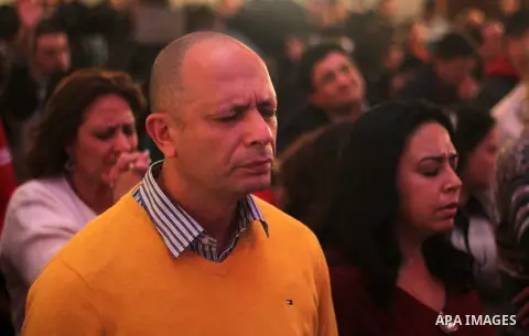Egyptian Christians attend a religious mass at the Kasr El Dobara Evangelical Church to celebrate New year in Cairo, Egypt on December 31, 2016. Photo by Stringer