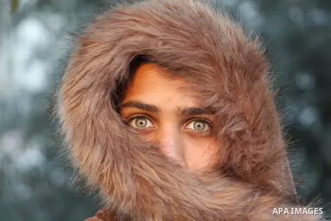 A young boy with a green eyes looking sharply. Photo by Sanad Ltefa