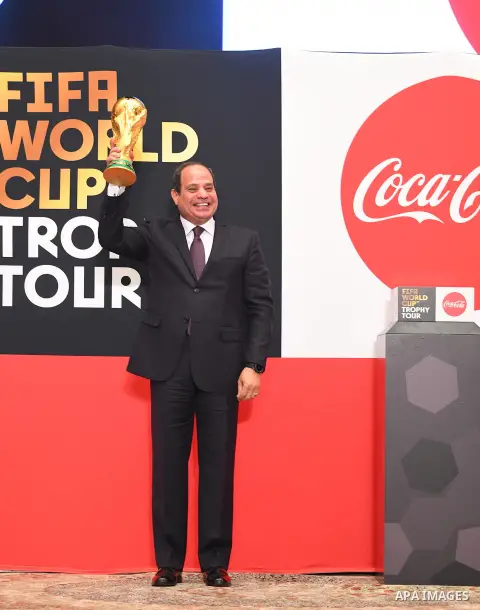 A handout picture released by the Egyptian Presidency on March 15, 2018 shows Egyptian President Abdel Fattah al-Sisi holding the FIFA World Cup Trophy as it tours the globe ahead of the 2018 FIFA World Cup tournament in...