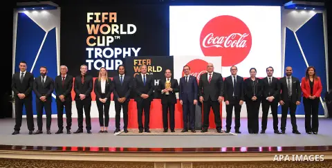 A handout picture released by the Egyptian Presidency on March 15, 2018 shows Egyptian President Abdel Fattah al-Sisi (C) holding the FIFA World Cup Trophy as it tours the globe ahead of the 2018 FIFA World Cup tournamen...