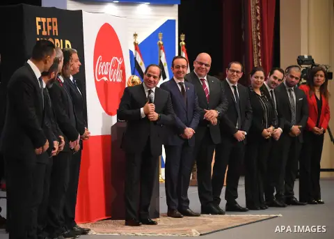 A handout picture released by the Egyptian Presidency on March 15, 2018 shows Egyptian President Abdel Fattah al-Sisi (C-L) speaking before the FIFA World Cup Trophy as it tours the globe ahead of the 2018 FIFA World Cup...