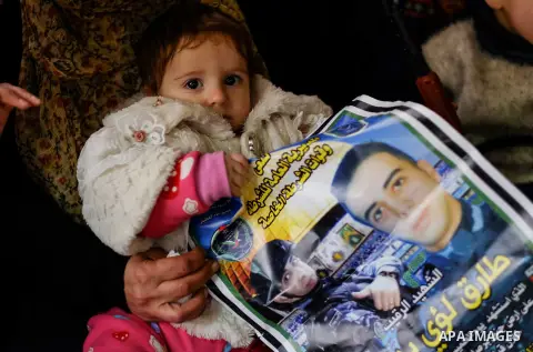 Relatives of Palestinian police officer Tareq Badwan, who was killed in Jenin, mourn during his funeral in the West Bank village of Azoun near Qalqilya, on February 7, 2020. Badwan was shot while standing at the entrance...