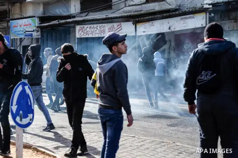 Israeli security forces fires tear gas towards Palestinian protesters during clashes with Israel security forces following the funeral of the martyr Tariq Badwan in the West Bank village of Azoun near Qalqilya, on Februa...
