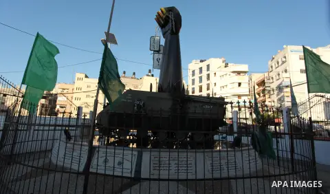 A picture taken on January 1, 2017 shows an iron fist monument holding a soldier's number plate with Oron Shaul written on it in Arabic in Gaza City. Hamas's military wing on December 31, 2016 released videos of a mock b...