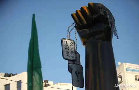 A picture taken on January 1, 2017 shows an iron fist monument holding a soldier's number plate with Oron Shaul written on it in Arabic in Gaza City. Hamas's military wing on December 31, 2016 released videos of a mock b...