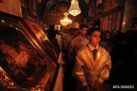 Palestinian Orthodox Christian altar boys attend a Christmas mass at the Saint Porphyrios Greek Orthodox church in Gaza City on January 7, 2017. According to the Gregorian calendar, Orthodox Christmas falls 13 days after...