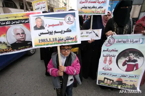 Palestinian supporters of the Islamic Jihad Movement, hold placards during a protest to show solidarity with Palestinian prisoners held in Israeli Jails, in front of Red cross office in Gaza city, on January 17, 2017. Ph...