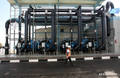 A Palestinian worker walks outside the Seawater Desalination Plant-Southern Gaza during the inauguration ceremony which completed with generous support from the European union Implemented by UNICEF in partnership with Pa...
