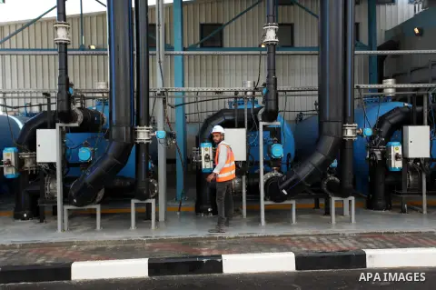 A Palestinian worker checks of pipes during the inauguration ceremony of The First Phase of the Seawater Desalination Plant-Southern Gaza completed with generous support from the European union Implemented by UNICEF in p...