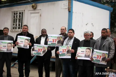 Palestinians hold placards during a protest to show solidarity with Palestinian prisoners in Israeli jails, in front of the high commissioner for human rights headquarters, in Gaza city, on January 26, 2017. Photo by Ash...