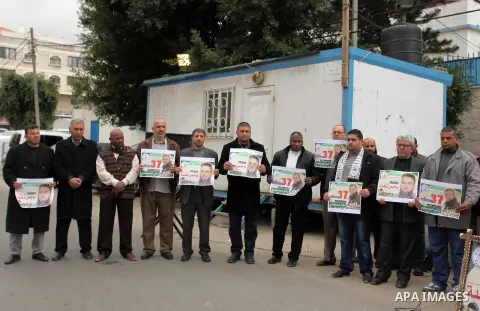 Palestinians hold placards during a protest to show solidarity with Palestinian prisoners in Israeli jails, in front of the high commissioner for human rights headquarters, in Gaza city, on January 26, 2017. Photo by Ash...