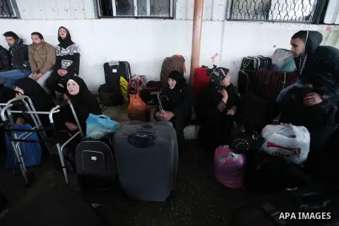Palestinians wait for travel permits to cross into Egypt through the Rafah border crossing after it was opened by Egyptian authorities for humanitarian cases, in Rafah in the southern Gaza Strip January 28, 2017. Photo b...