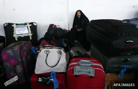 Palestinians wait for travel permits to cross into Egypt through the Rafah border crossing after it was opened by Egyptian authorities for humanitarian cases, in Rafah in the southern Gaza Strip January 28, 2017. Photo b...