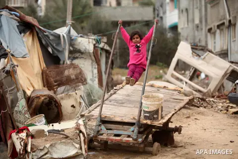 A Palestinian girl plays outside a hovel during the cold weather in the Jabalia refugee camp in the northern Gaza Strip on January 29, 2017. Photo by Ashraf Amra