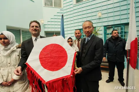 Japanese Ambassador to Palestine, Takeshi Okubo, and Commissioner-General of the UN Relief and Works Agency (UNRWA) Pierre Krahenbuhl, help Palestinian students to prepare kites at the headquarters United Nations Relief...