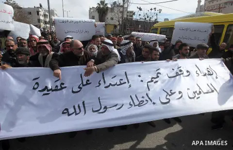 Palestinian protesters take part in a demonstration organised by Hizb el-Tahrir against what they say is a decision by Palestinian Authority granting an Islamic land to a Russian church in the West Bank city of Hebron Fe...