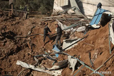 Palestinians inspect the damage to a chicken farm in Gaza City's eastern suburb of Shujaiya on February 7, 2017, following a series of strikes carried out the day before by Israeli forces against the Hamas movement in th...