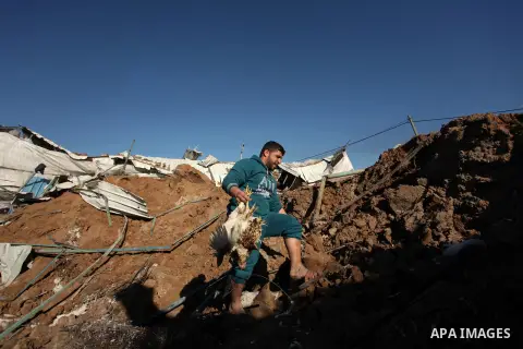 Palestinians inspect the damage to a chicken farm in Gaza City's eastern suburb of Shujaiya on February 7, 2017, following a series of strikes carried out the day before by Israeli forces against the Hamas movement in th...
